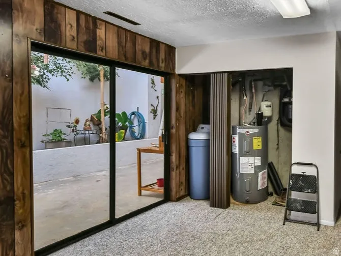 Room featuring wood-finish paneling and light-colored carpeting