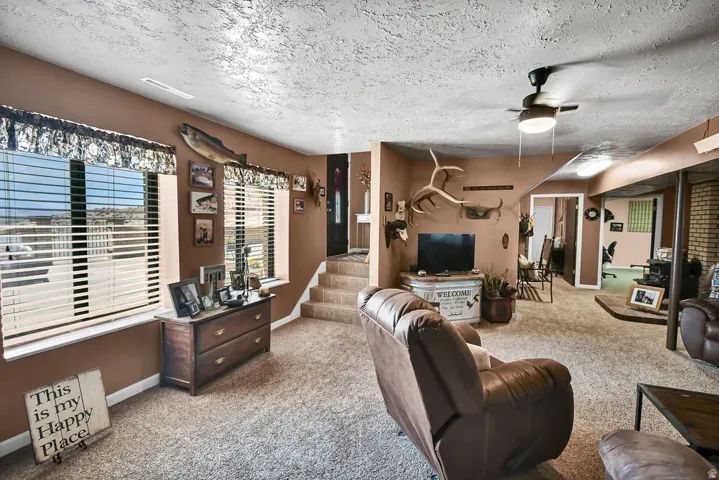 Spacious interior featuring neutral carpeting and textured ceilings