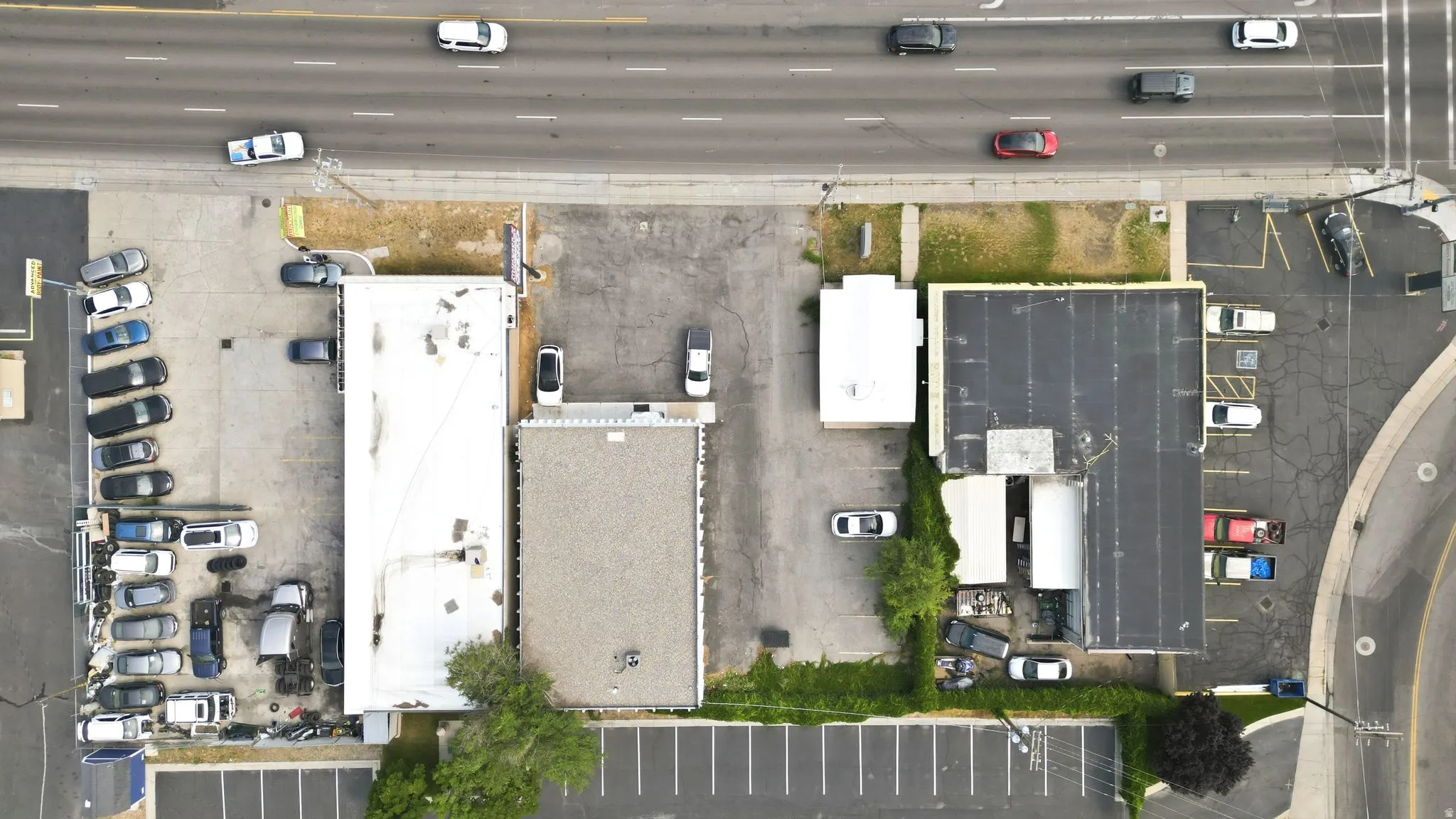 Aerial view showcasing three commercial buildings with diverse roofing