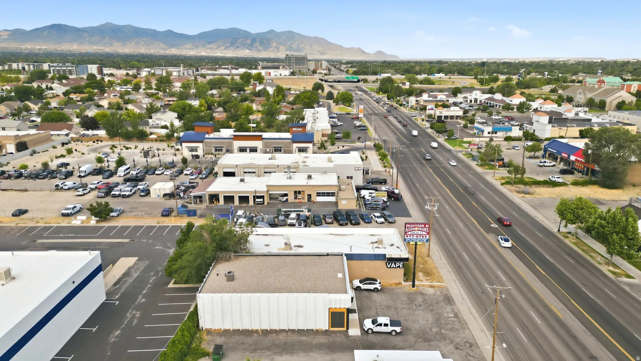 Commercial property featuring an expansive parking area and prominent street frontage