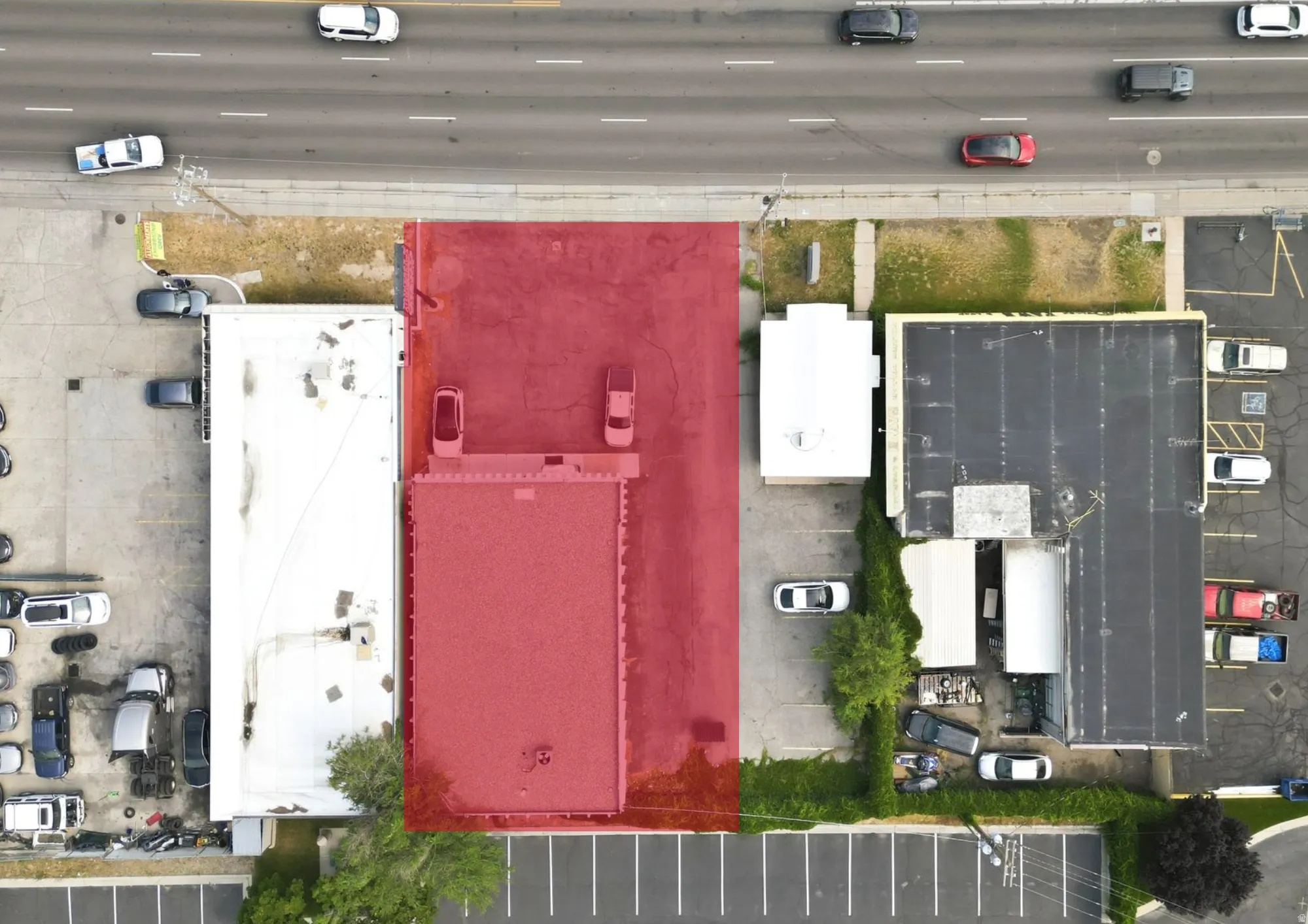 Aerial view of a commercial property featuring a flat roof structure