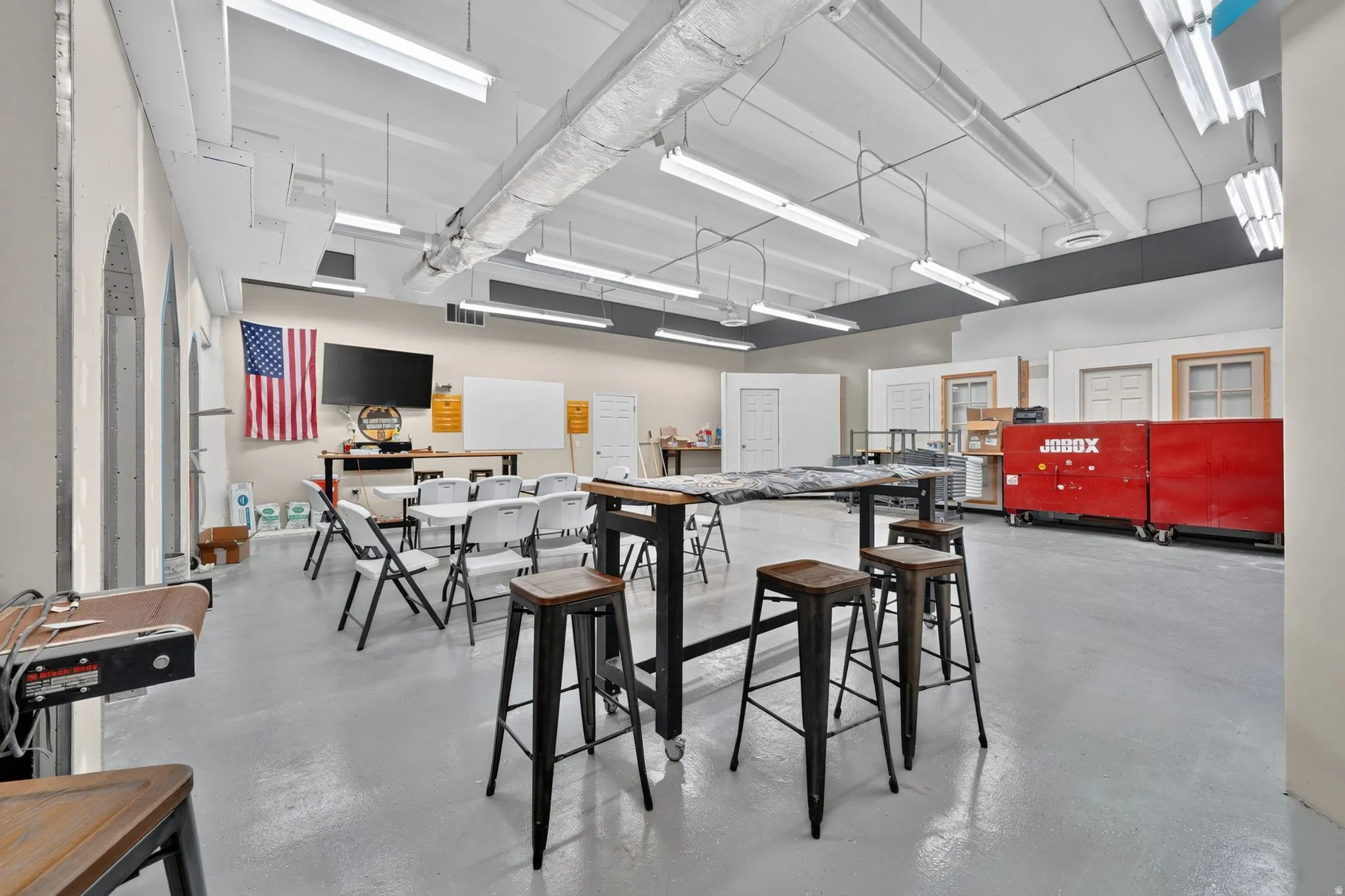 Spacious interior with high ceilings and exposed ductwork