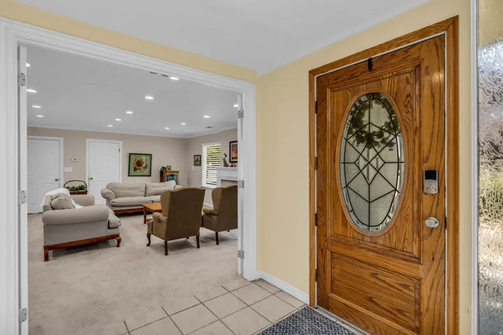 Solid wood entry door with an oval leaded glass insert and sidelight