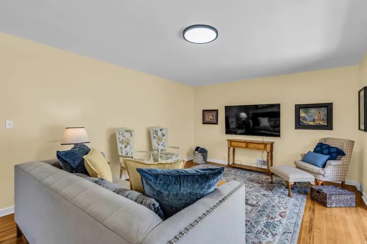 Living area featuring wood-finish flooring and light-toned walls