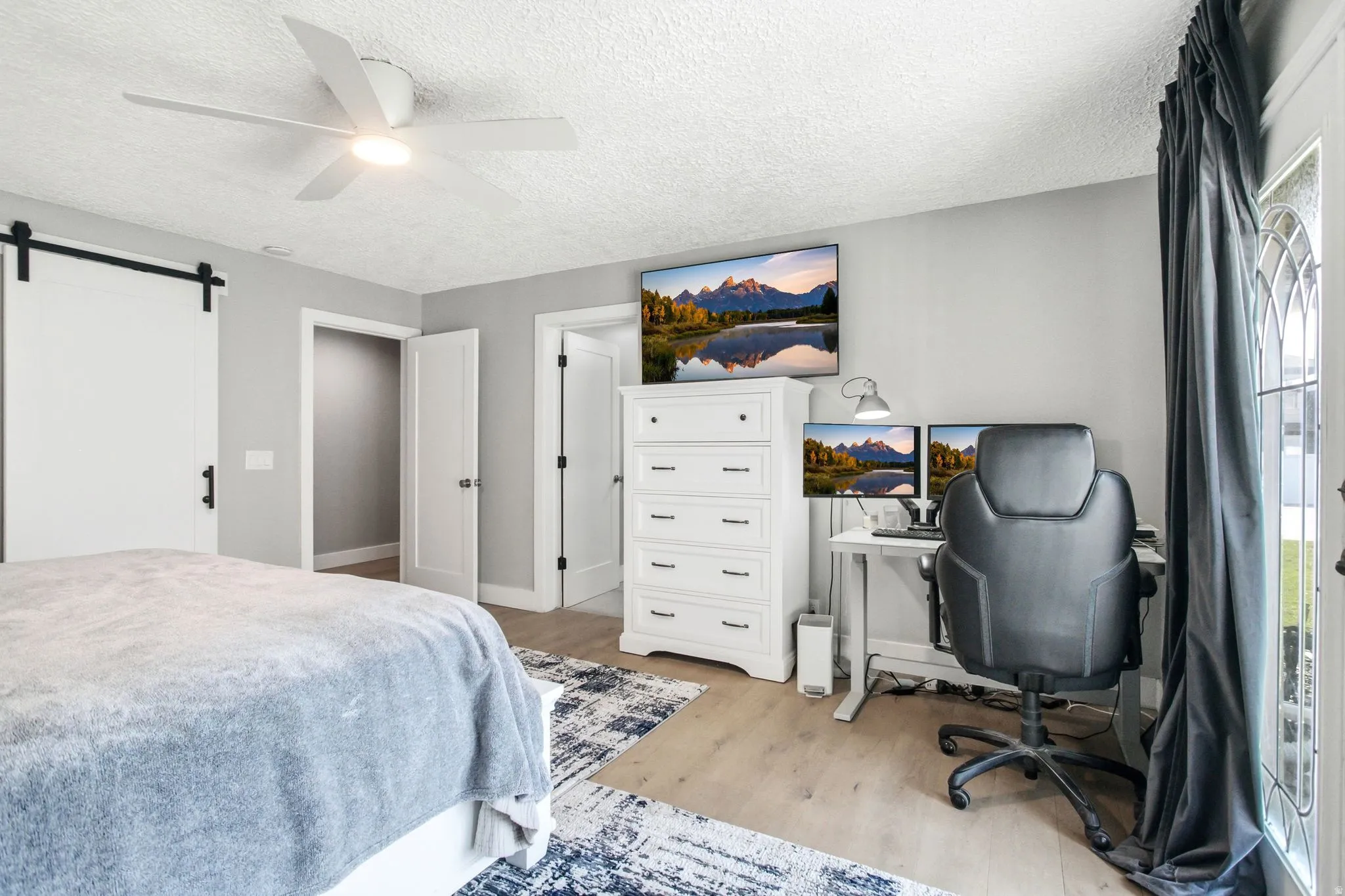 Light-toned wood-finish flooring complements the neutral wall color