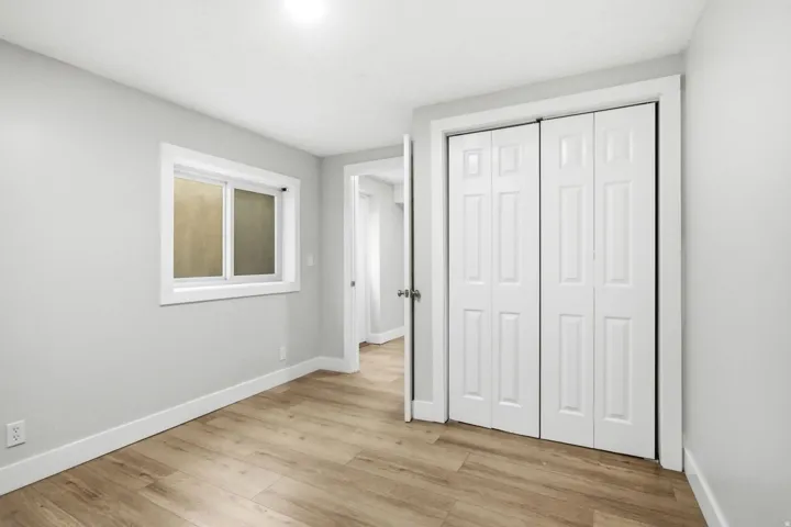 Light wood-finish flooring complements the neutral wall color