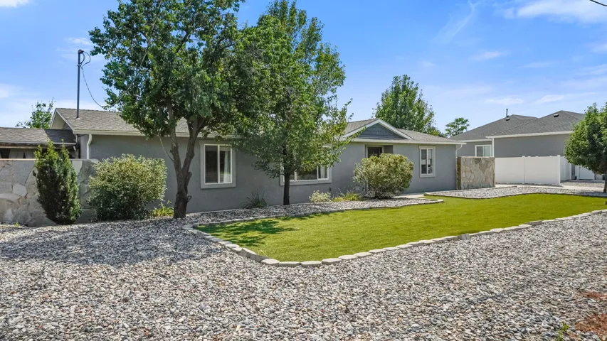 Contemporary stucco exterior with a gray roof and white trim