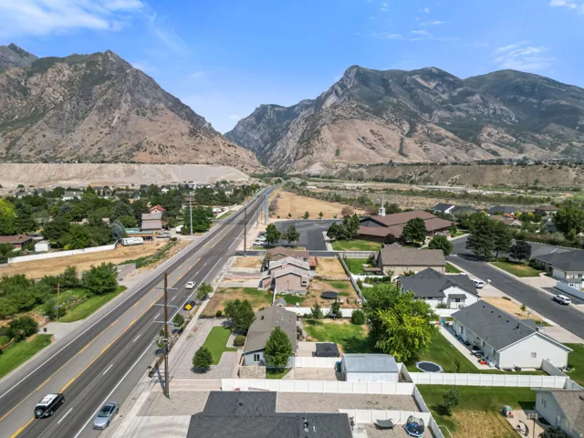 Aerial perspective showcasing a residential area situated at the base of extensive mountains