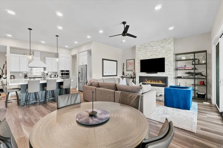 Open-concept living space featuring wood-finish flooring, recessed lighting, and a contemporary ceiling fan