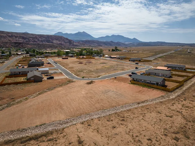 Expansive undeveloped land parcel featuring existing paved roads and utilities