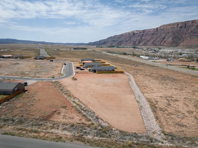 Expansive undeveloped lot featuring a defined property boundary and a gradual slope