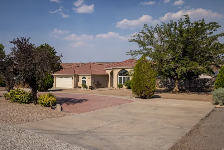 Stucco exterior residence with a terracotta tile roof and an attached two-car garage