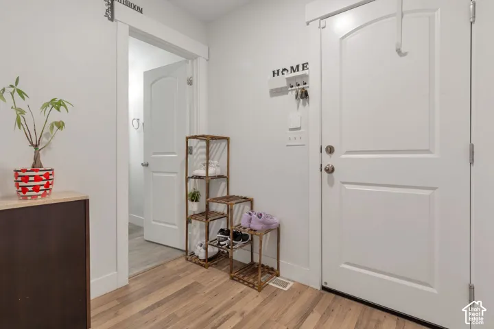 Light wood-finish flooring complements white walls and trim