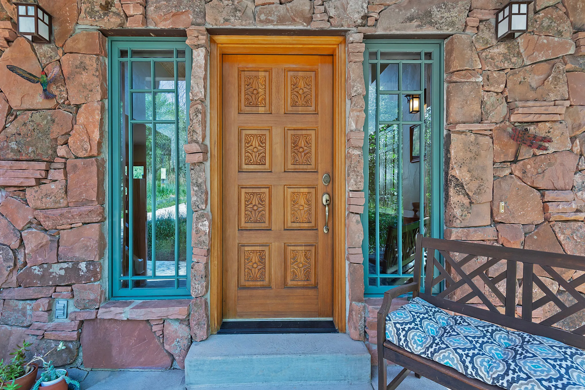 Stone veneer exterior featuring an ornate wood-paneled entry door
