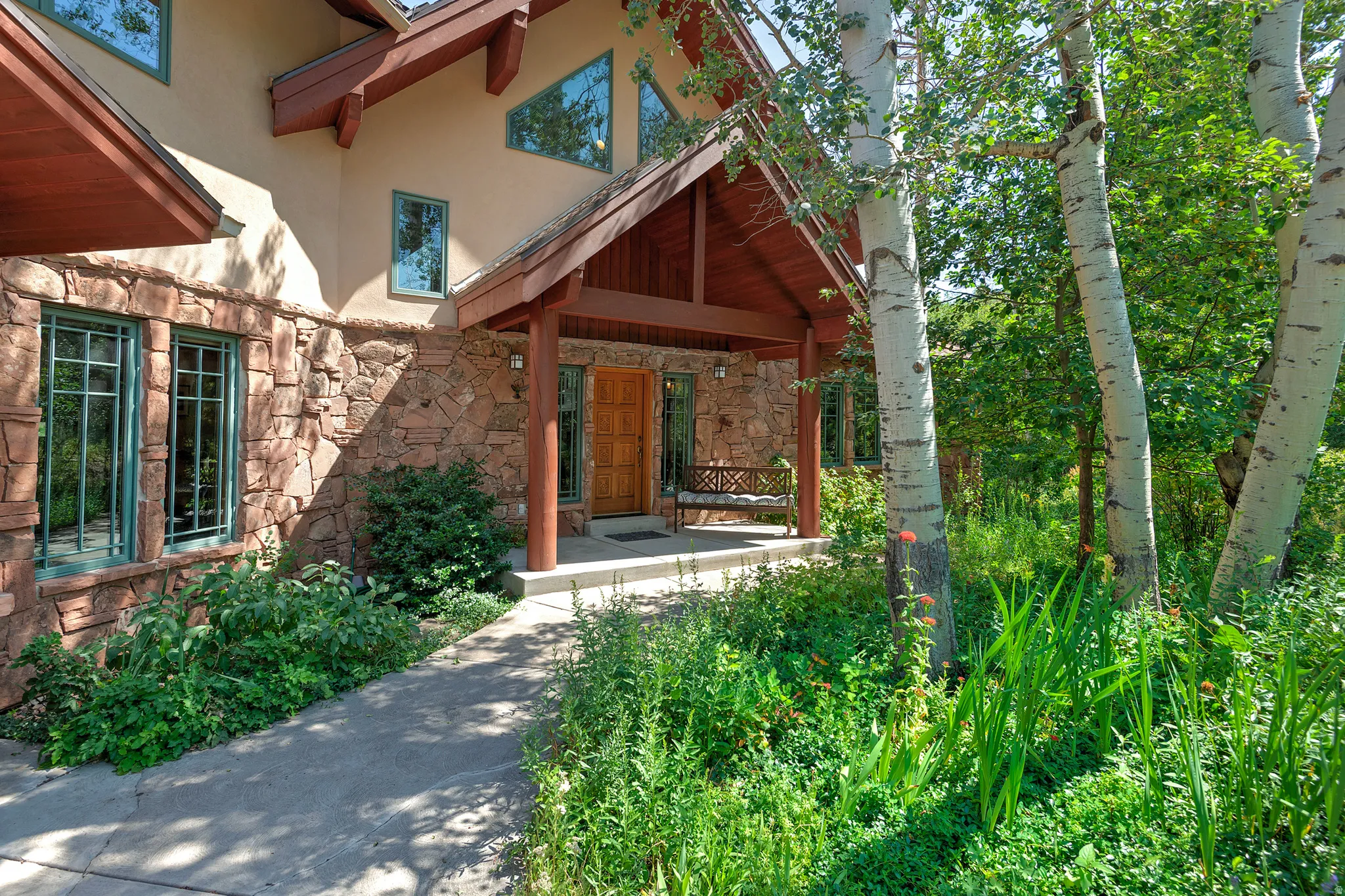 Stone and stucco exterior with a covered entry