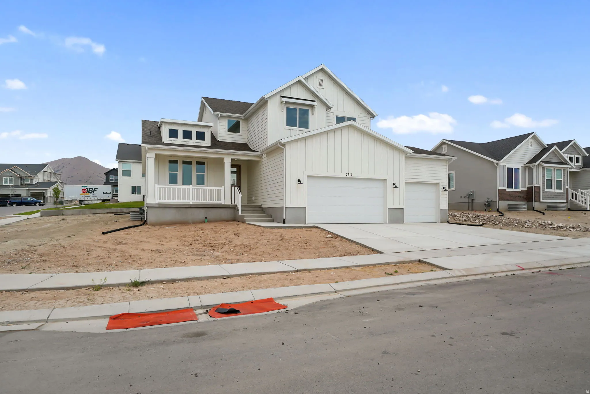 Two-story residence featuring white siding and a covered front porch with white railing