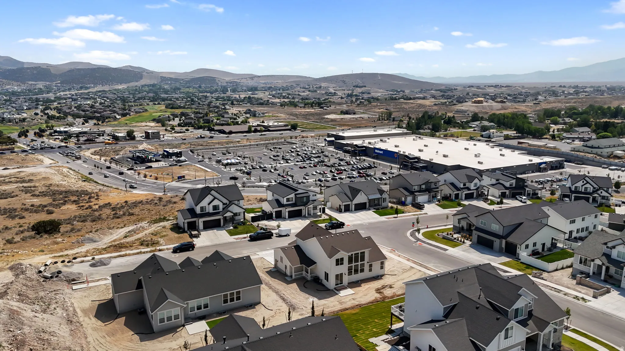 Aerial view showcasing a residential neighborhood with a distant mountainous backdrop