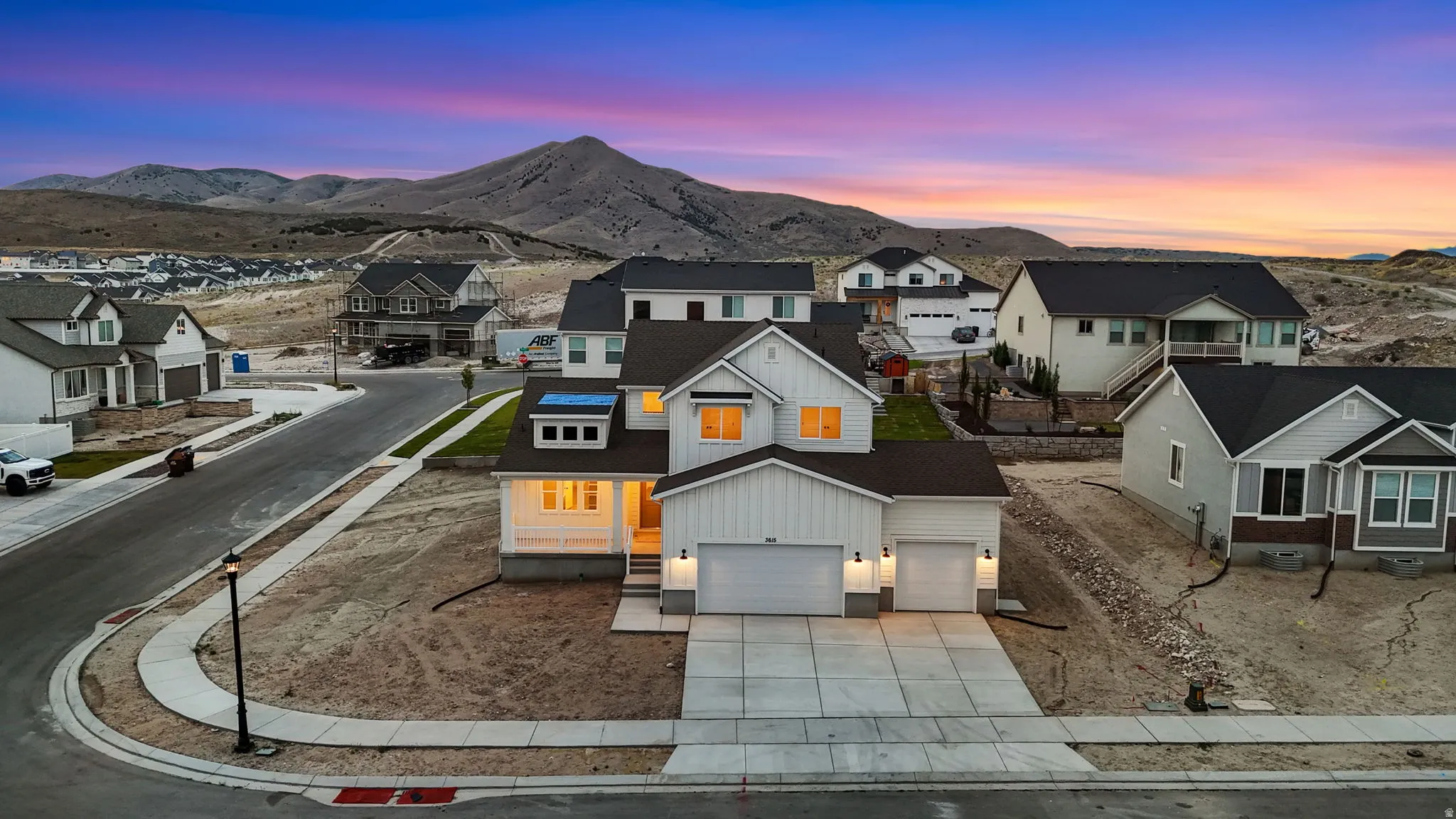 Contemporary two-story residence featuring white vertical siding and dark roofing