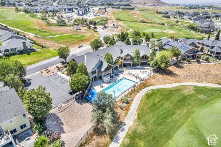 Community recreation area featuring a fenced swimming pool, adjacent spa, and sun loungers