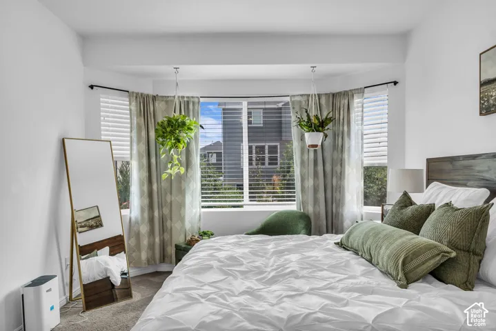 Bay window with horizontal blinds and drapery panels