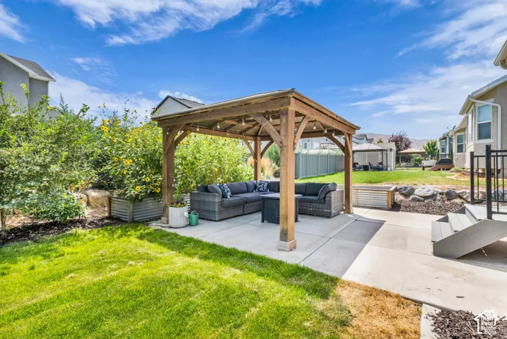 Expansive backyard featuring a wood pergola over a concrete patio
