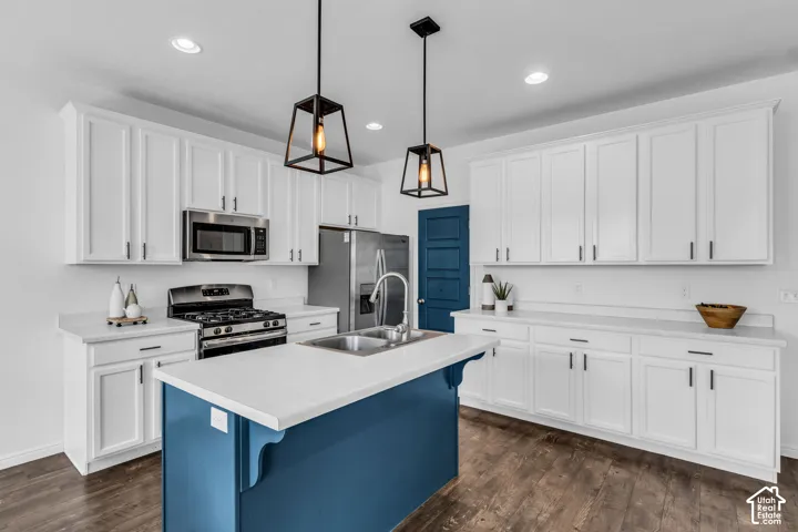 Modern kitchen featuring a blue-painted island with a white countertop