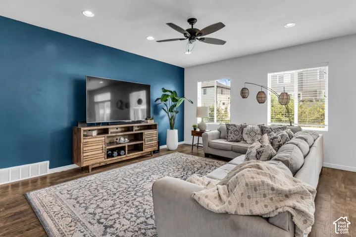 Spacious living area featuring wood-finish flooring, recessed lighting, and a ceiling fan