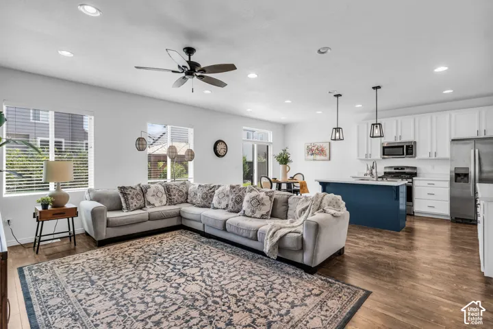 Open-concept living area featuring wood-finish flooring and recessed lighting throughout