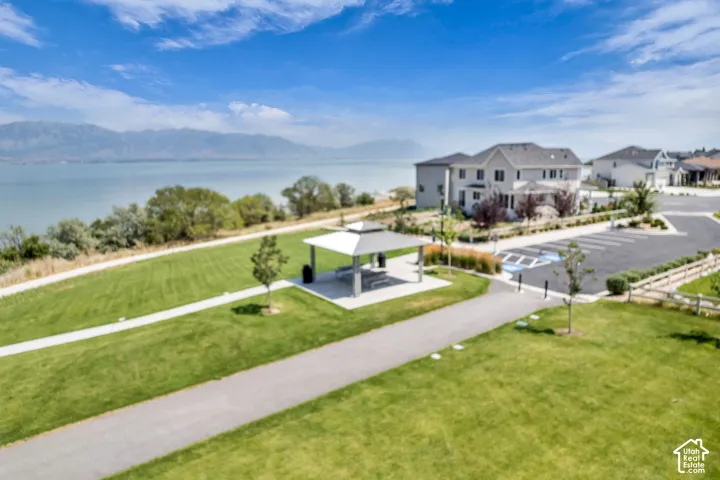 Expansive green space with paved walking paths and a covered picnic area