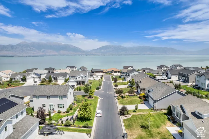 Residential community featuring a variety of home styles, manicured lawns, and a paved street