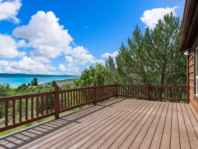 Expansive outdoor deck featuring wood-finish decking and a stained wood railing