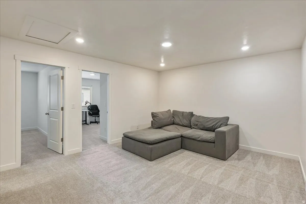 Spacious room with light gray carpet and recessed ceiling lighting