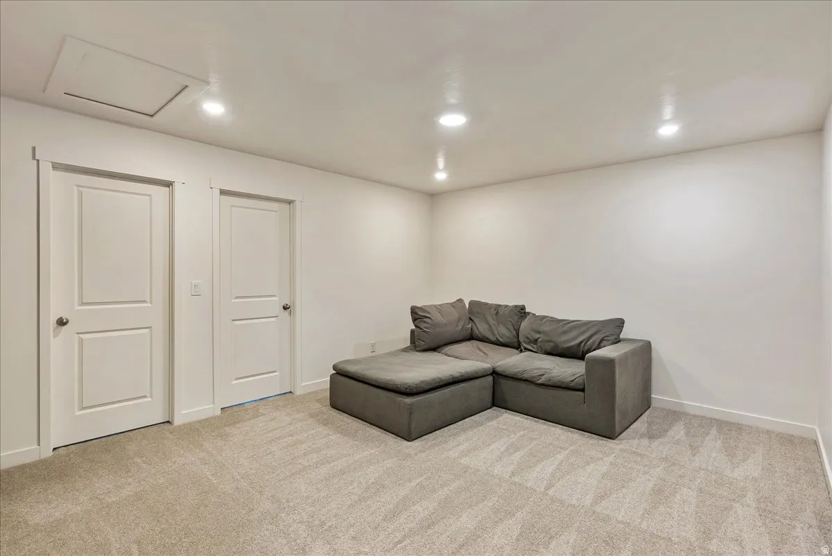 Carpeted room with recessed lighting and two panel doors