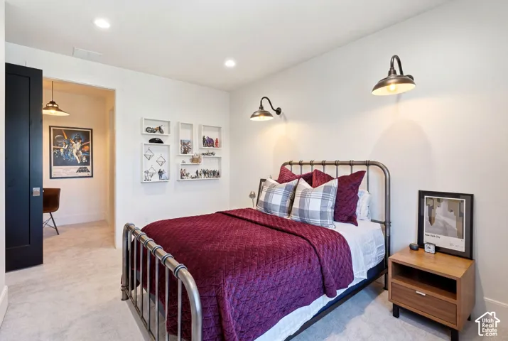 Interior bedroom featuring light gray carpet flooring and white walls