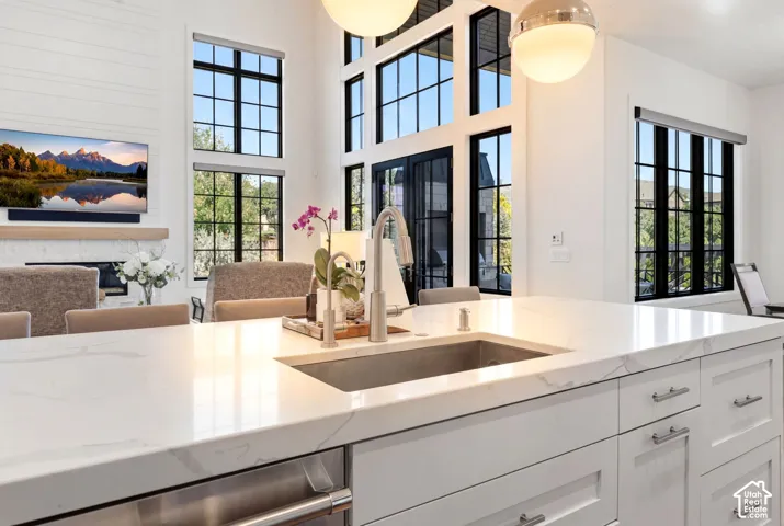 Expansive kitchen island featuring a light-toned countertop with integrated sink and contemporary faucet