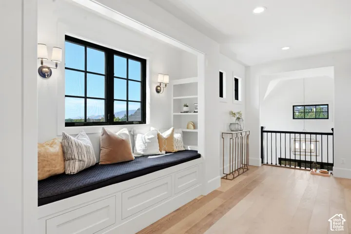 Built-in window bench with storage, integrated shelving, and dual sconce lighting