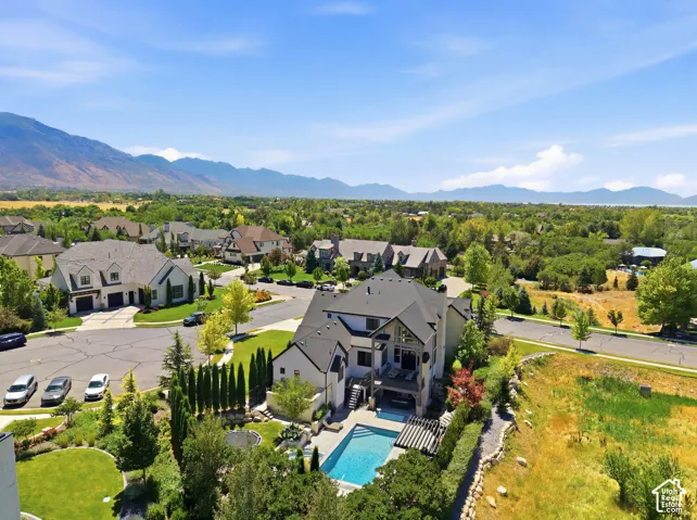 Contemporary residence featuring a multi-level deck, integrated swimming pool, and manicured landscaping