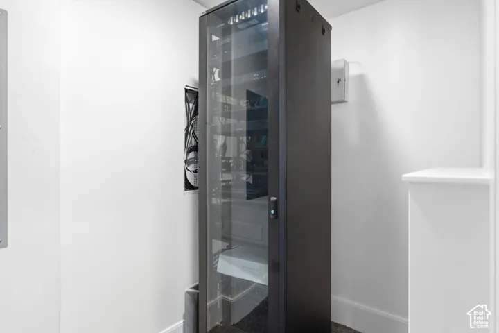 Integrated network rack with a glass front panel and internal shelving