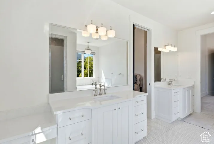 Dual white vanity areas featuring ample storage and under-mount sinks