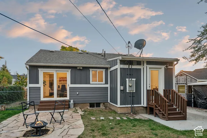Back exterior featuring gray siding with white trim