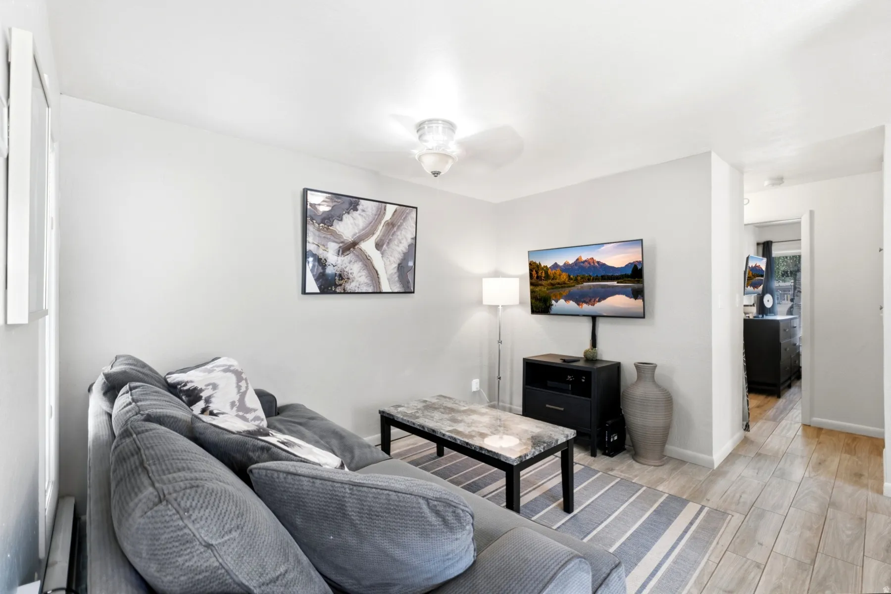 Light gray wall paint complemented by wood-finish flooring