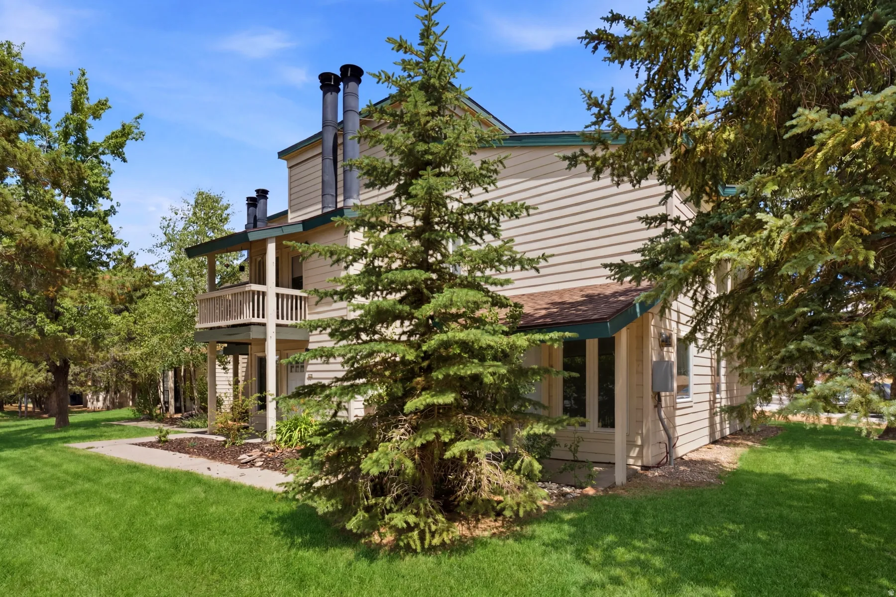 Multi-level residence featuring horizontal siding and dark trim accents