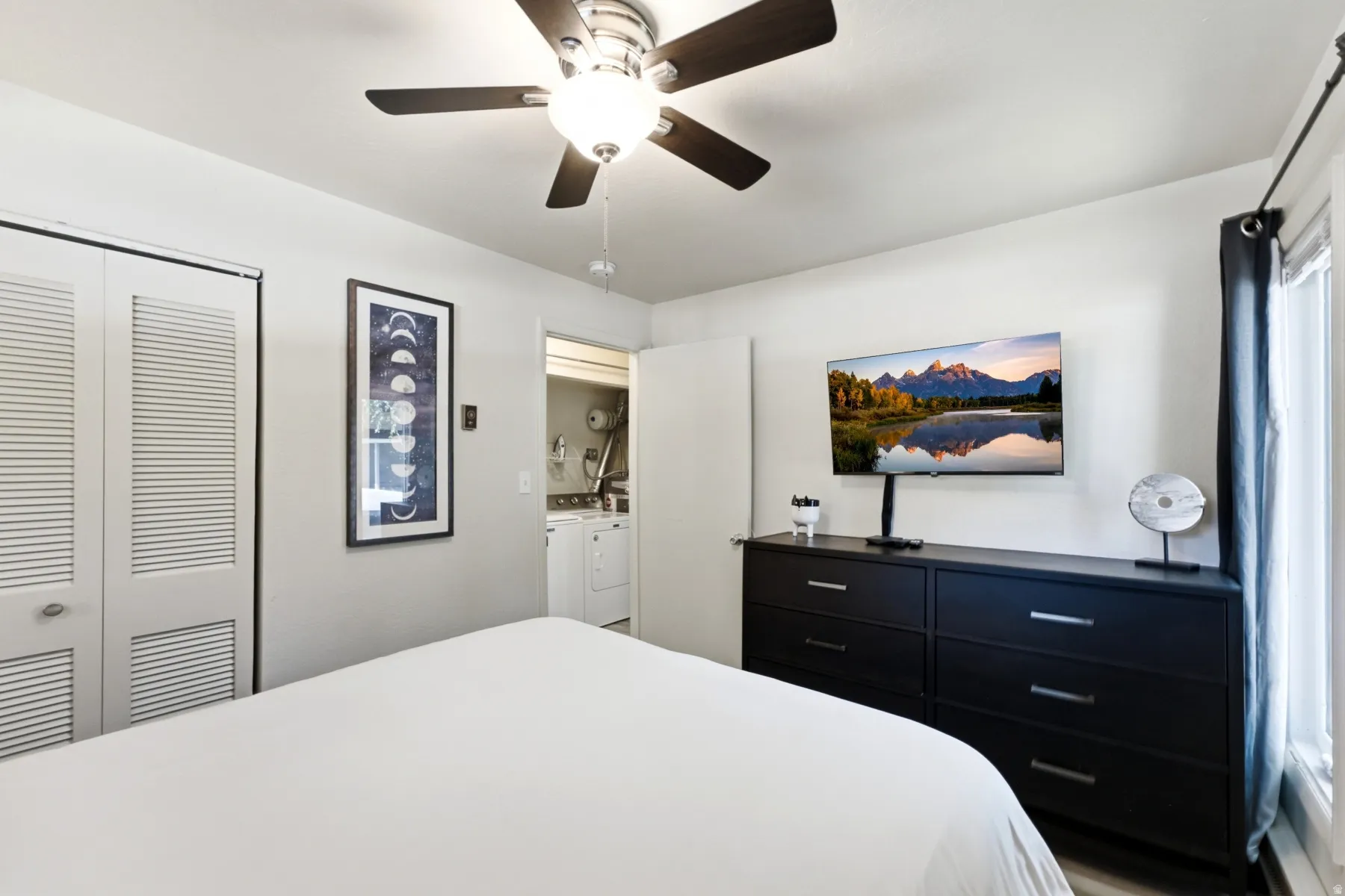 Room featuring light-toned walls and wood-finish flooring