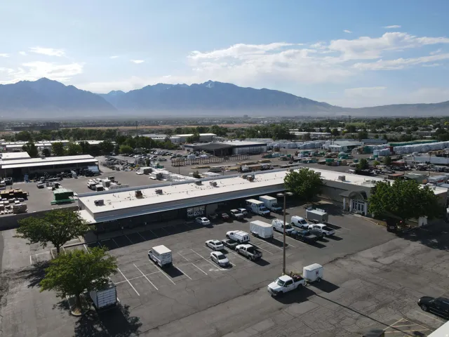 Expansive commercial complex featuring multiple buildings with flat roofs and ample parking