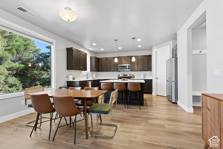 Open-concept living space with wood-finish flooring