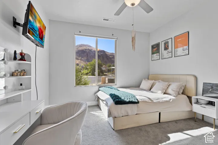 Bedroom featuring light gray carpet flooring and white walls