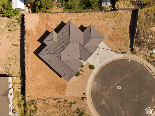 Aerial perspective showcasing a newly constructed residence with a multi-gabled roofline