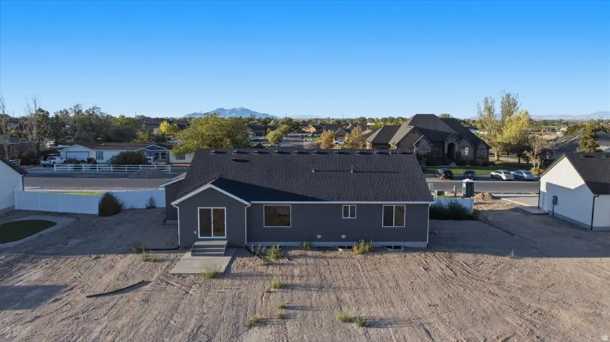 Contemporary gray siding exterior with dark shingle roofing