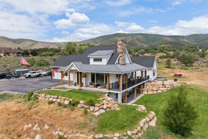 Modern farmhouse exterior with white siding and dark shingle roofing