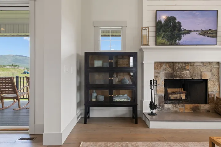 Stone fireplace with a shiplap accent wall and a built-in mantel
